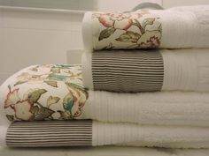 towels stacked on top of each other in a bathroom