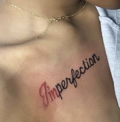 a woman's chest with the word imperfect written in cursive writing on it