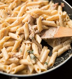 a skillet filled with pasta and meat