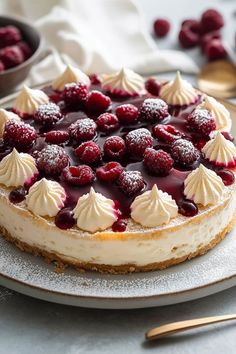 a cheesecake topped with raspberries and whipped cream