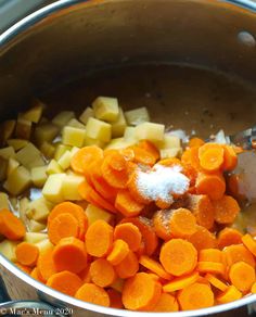 carrots, potatoes and sugar are being cooked in a pot on the stove top