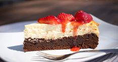 a piece of cheesecake with strawberries on top is sitting on a white plate