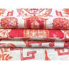 three red and white fabric pieces on top of each other, one with an ornate design