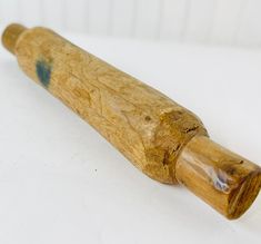 an old wooden baseball bat sitting on top of a white table