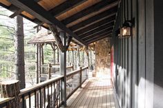 the porch is covered with wood and has metal railings on both sides that lead to an observation platform