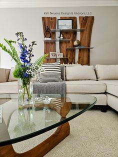 a living room with a glass table and couches