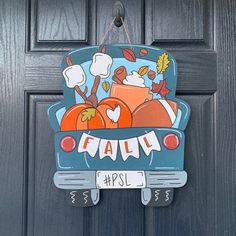 a door hanger with an image of pumpkins in the trunk