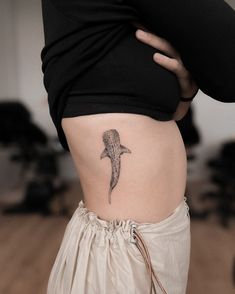 a woman's stomach with a shark tattoo on her belly and the bottom part of her lower body