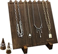 there are many different necklaces displayed on this wooden display stand with the name aurora written on it