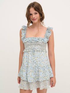 Perfect for capturing hearts, this vintage-inspired blue mini dress is your go-to for everyday elegance. Crafted in an allover garden floral print, this fit and flare dress has a squared ruffled neckline, a smocked bodice, and a full ruffled skirt. Mini Dress Blue, Everyday Elegance, Ruffled Neckline, Ruffled Skirt, Wedding Lingerie, Blue Mini Dress, Bohemian Dress, Fall Dresses, Fit And Flare Dress