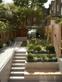 an outdoor garden with steps leading up to the house