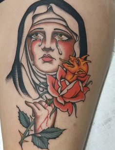 a woman with a rose tattoo on her thigh