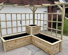 an outdoor garden with wooden planters and trelliss