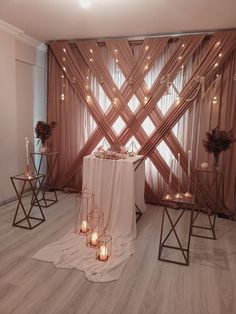 a white table topped with candles next to a window