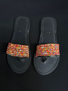 Unique Africa Maasai Handcrafted Beaded Leather Sandals with an Elegant Look and Brilliant Finish. Color =Multi Color. Size = Optional. **GET FREE SHIPPING FOR ADDITIONAL ITEMS PURCHASED. Yes, Buy Multiple Items and pay shipping for 1 item only- The rest ships Free. (No Limits on the number of Multiple items). With a faster delivery time of 3 days via DHLExpress, Worldwide. Ordinary/Standard Shipping also available upon request. We Custom Make to Suit Your Taste. Available In All Colors and Size Handmade Adjustable Slip-on Sandals, Handmade Slip-on Festival Sandals, Handmade Slip-on Sandals For Festival, Handmade Flat Adjustable Sandals, Handmade Adjustable Flat Sandals, Handmade Black Flip Flops, Handmade Multicolor Flat Sandals, Handmade Traditional Red Sandals, Traditional Handmade Red Sandals