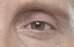 an older woman's brown eye with wrinkles