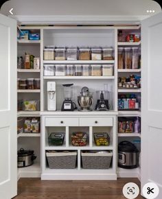 an organized pantry with white shelves and baskets