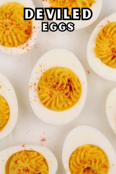 deviled eggs with yellow stuff in them on a white surface