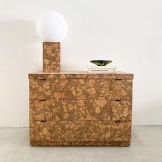 a marbled dresser with a lamp on top