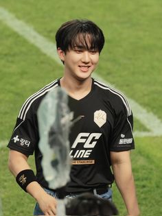 a young man standing on top of a soccer field