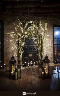 an indoor area with lanterns, flowers and candles