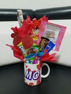 a coffee mug filled with candy and candies