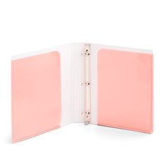 a pink binder is open on top of a white background