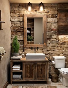 a rustic bathroom with stone walls and wood accents, including a wooden vanity sink cabinet