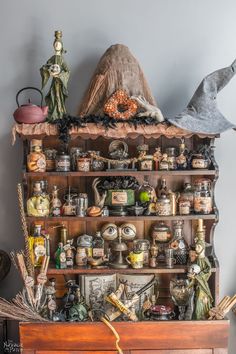 an old wooden shelf with many items on it and a bird figurine sitting on top