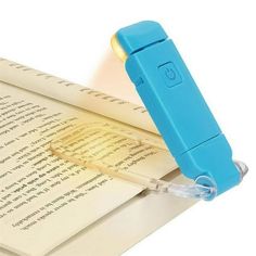 an open book with a blue pen sticking out of it