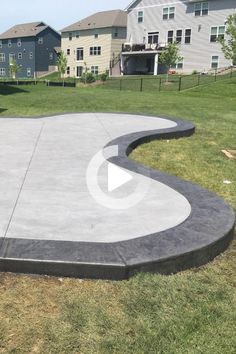 a skateboarder is doing tricks on a concrete ramp in a yard with houses in the background