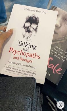 a person holding up a book in front of their face with the title talking with psychpaths and savages