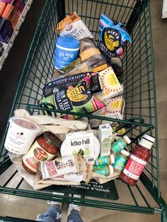 a shopping cart filled with food and condiments