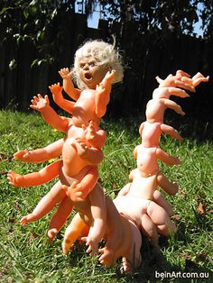 two dolls are playing in the grass with fake carrots on their heads and arms