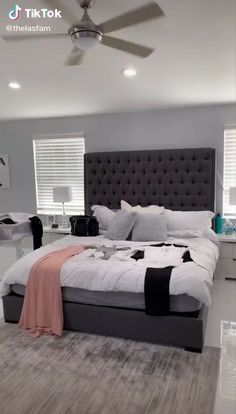 a bedroom with a large bed and ceiling fan