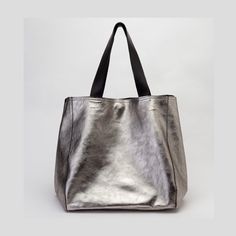 Metallic leather bag handmade in our atelier with premium metallic leather. This large-size bag (available in two sizes, large and extra-large versions, see options) has reinforced leather handles for wearing it on the shoulder or by hand.  It's a trendy silver leather tote bag with the magic touch of metallic leather.  Top closure by two leather straps and one magnetic clasp. The soft leather allows the bag to take different shapes. On the shoulder or by hand is always a stylish purse.   Availa Silver Tote Bag, Metallic Leather Bag, Waist Bag Leather, Soft Leather Tote, Slouchy Bag, Soft Leather Handbags, Large Leather Tote Bag, Silver Bags, Stylish Purse