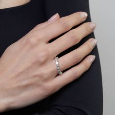 a woman's hand wearing a diamond ring