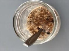 a glass jar filled with oatmeal sitting on top of a table