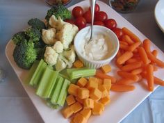 a white plate topped with carrots, cauliflower and broccoli