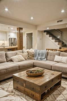 a living room filled with furniture and a wooden table on top of a carpeted floor