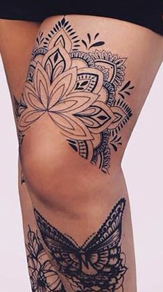 a woman's thigh with tattoos on it