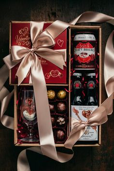 a wine gift box filled with chocolates, champagne and liquor bottles for valentine's day