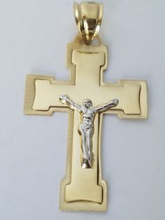 100% Real solid 14k GOLD A Beautiful solid real 14 yellow gold crucifix Jesus cross pendant charm . High polish finish. Excellent quality and beautiful design . It is hallmarked 14k on the bail for authenticity Approximate measurements Length:1.85 long including the bail Width: 1 inch wide Weight: 2.5 Bail size: fits up to 7x6.5 mm wide chains The size is compared to a quarter. See pics for sizes and detail. Please acknowledge the sizes, it may appear bigger in pics. Order from us with confidenc Spiritual White Cross Jewelry, White Spiritual Cross Pendant Jewelry, White Spiritual Crucifix Jewelry, Spiritual White Crucifix Jewelry, White Engraved Cross Necklace, White Spiritual Cross Jewelry And Charms, White Spiritual Jewelry With Large Pendant, White Engraved Pendant Jewelry, Yellow Cross Jewelry Gift