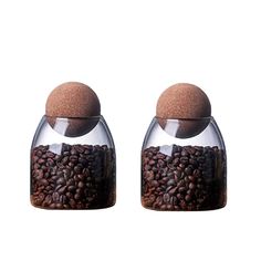 two salt and pepper shakers filled with coffee beans