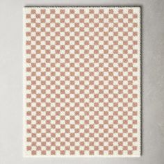 a white and brown checkerboard pattern on a wall with a light gray background