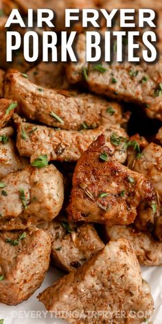 grilled pork bites on a white plate with parsley