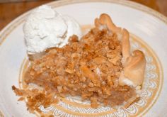 a piece of pie on a plate with ice cream