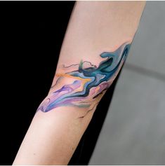 a woman's arm with an abstract tattoo design on the left side of her arm