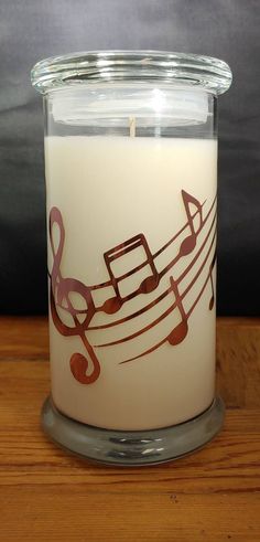 a candle with musical notes painted on it