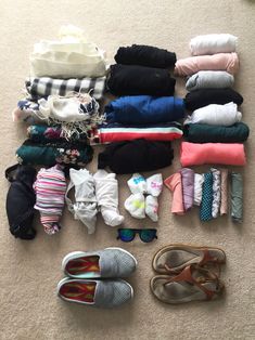 many pairs of shoes are laid out on the floor next to each other, including baby ones